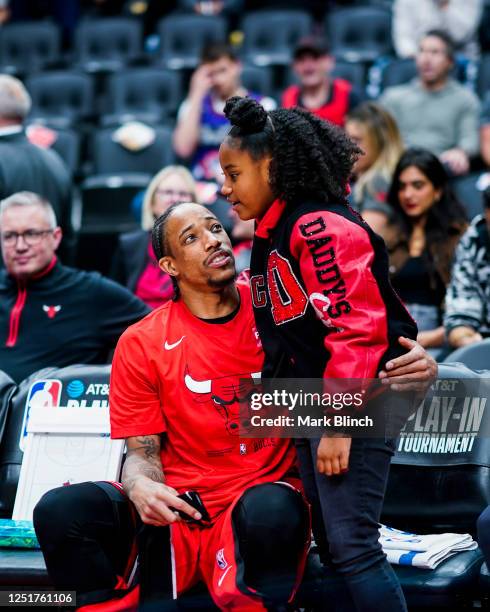 DeMar DeRozan of the Chicago Bulls embraces his daughter before the game against the Toronto Raptors during the 2023 Play-In Tournament on April 12,...