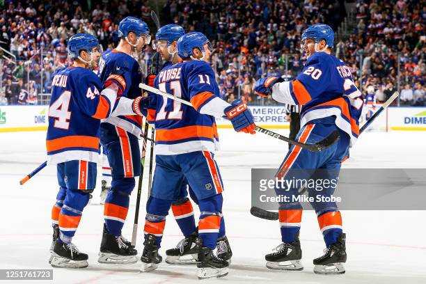 Hudson Fasching of the New York Islanders is congratulated by his teammates after scoring a goal against the Montreal Canadiens during the first...