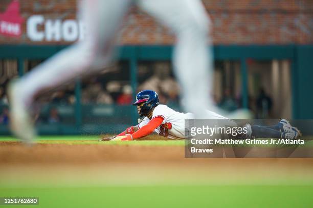 Ronald Acuña Jr. #13 of the Atlanta Braves steals second base during the second inning against the Cincinnati Reds at Truist Park on April 12, 2023...