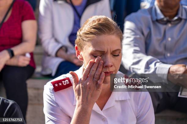 Salvation Army Captain Lacy Parrish sheds tears at a vigil at the Muhammed Ali Center for the five people killed in the April 10 shooting at the Old...