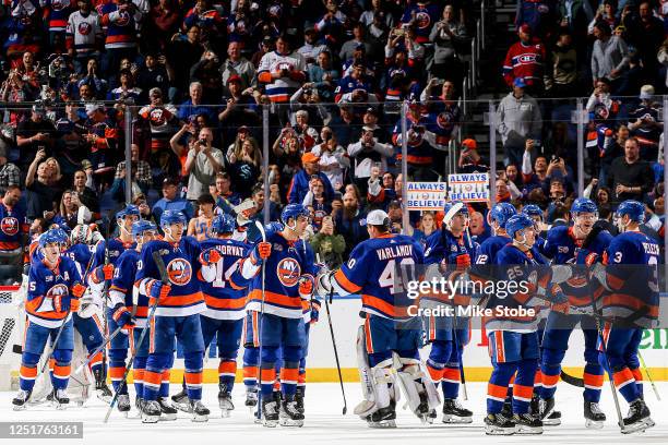 The New York Islanders celebrate their 4-2 victory against the Montreal Canadiens to secure a place in the Stanley Cup Playoffs at UBS Arena on April...