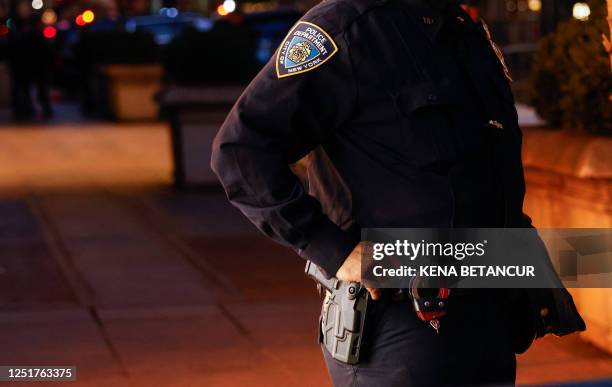 Officers guard outside Trump Tower in New York on April 12, 2023 as former US President Donald Trump who is scheduled to return to New York City...