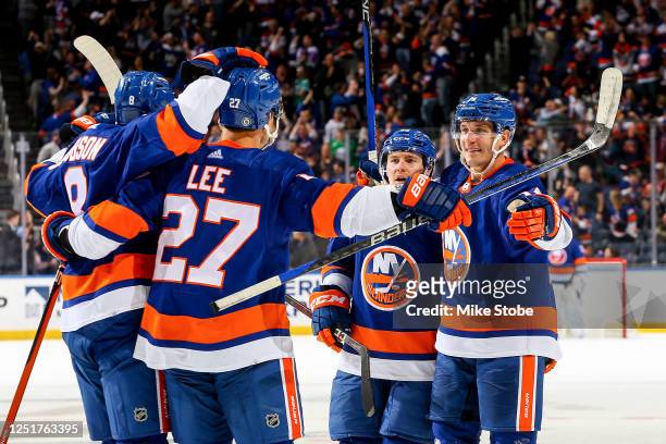Anders Lee of the New York Islanders is congratulated by his teammates after scoring a goal against the Montreal Canadiens during the third period at...