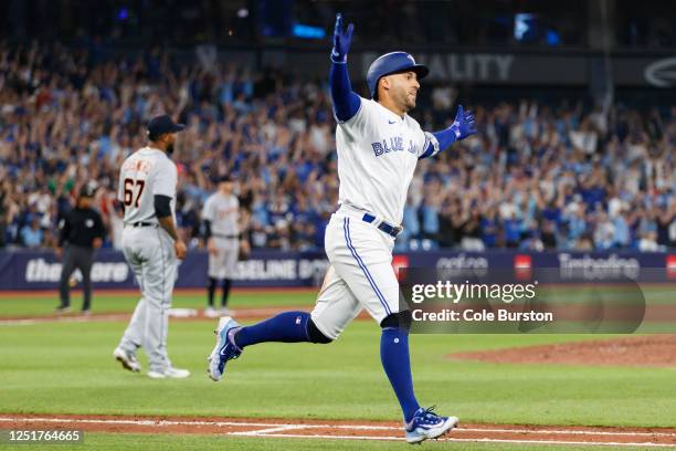 George Springer of the Toronto Blue Jays celebrates a walk-off single in the tenth inning of their MLB game against the Detroit Tigers at Rogers...