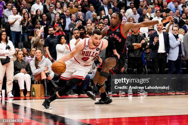 Zach LaVine of the Chicago Bulls drives past O.G. Anunoby of the Toronto Raptors during the 2023 Play-In Tournament at the Scotiabank Arena on April...