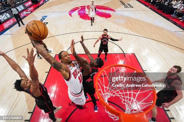 DeMar DeRozan of the Chicago Bulls goes to the basket against Scottie Barnes and Pascal Siakam of the Toronto Raptors during the 2023 Play-In...