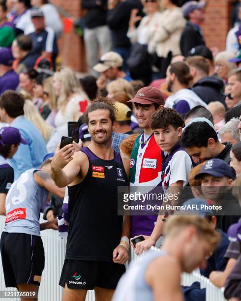 Alex Pearce of the Dockers takes a selfie with a fan during the Fremantle Dockers training session at Norwood Oval on April 13, 2023 in Adelaide,...
