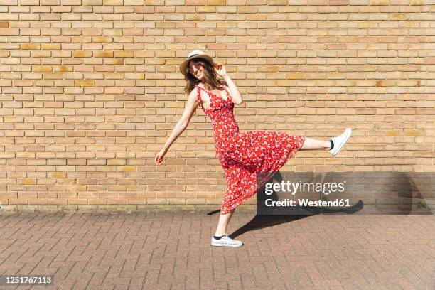 happy and carefree young woman outdoors - sommerkleid stock-fotos und bilder