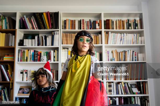 portrait of boy dressed up as a rock star in the living room with his younger brother - sunglasses disguise bildbanksfoton och bilder