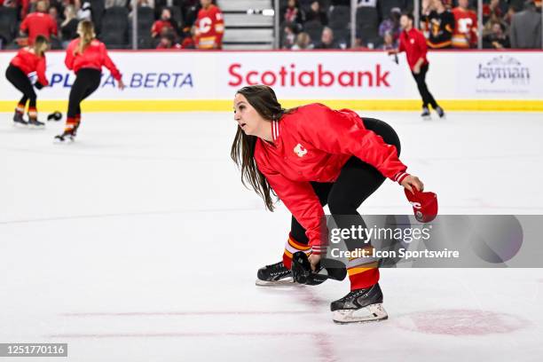 Calgary Flames ice girls pick up hats after Calgary Flames Defenceman Nikita Zadorov , not shown, scored his third goal of the game during the third...