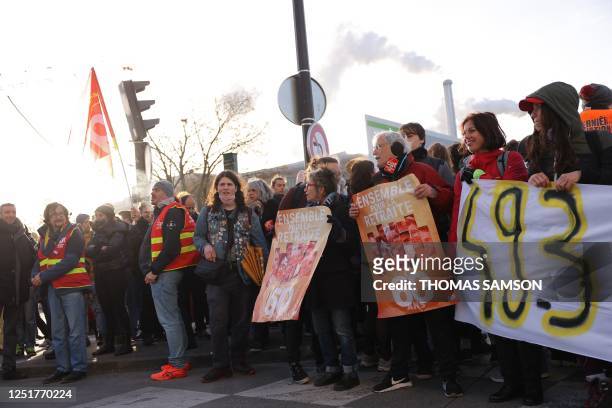 Demonstrators of French General Confederation of Labour trade union, holding a banner reading "Together for pension at 60", block the entrance of the...