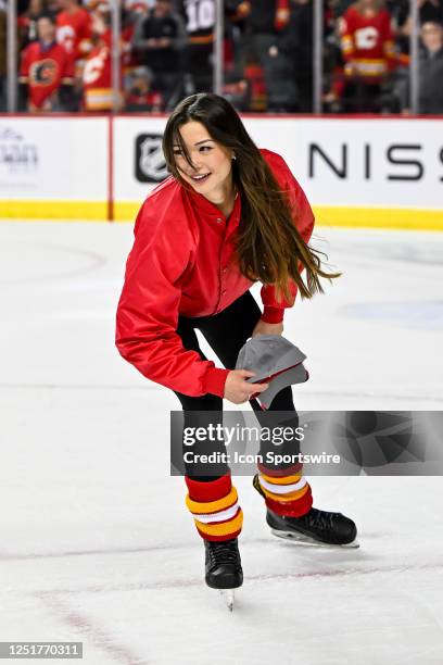 Calgary Flames ice girls pick up hats after Calgary Flames Defenceman Nikita Zadorov , not shown, scored his third goal of the game during the third...