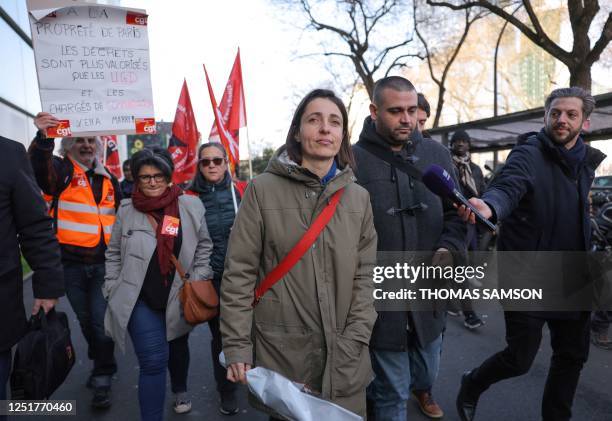 French General Confederation of Labour trade union General Secretary Sophie Binet holds a bunch of flowers as she walks with CGT unionists near the...