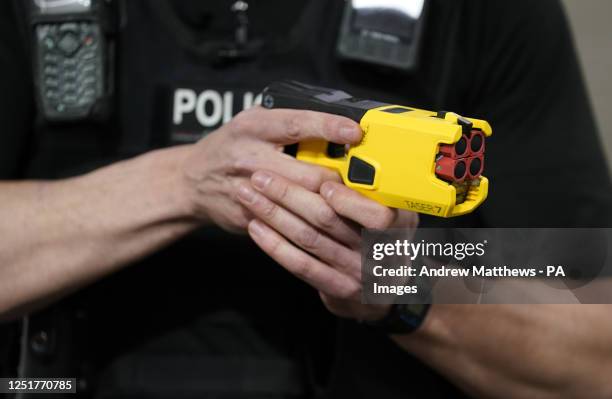 An officer holds the new Taser 7 during a demonstration as Hampshire and Isle of Wight Constabulary and Thames Valley Police launch the rollout of...