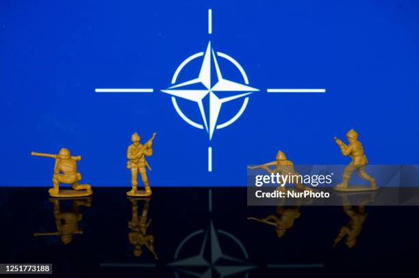 Illustration with figures of soldiers, seen in front of a NATO flag displayed on a computer screen is seen in L'Aquila, Italy, on april 11, 2023