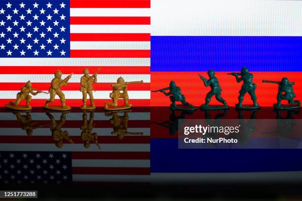 Illustration with figures of soldiers, seen in front of an USA and a Russia flag displayed on a computer screen is seen in L'Aquila, Italy, on april...