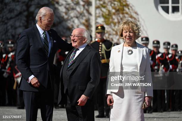 President Joe Biden is welcomed by Ireland's President Michael D Higgins and his wife Sabina at the Aras an Uachtarain in Dublin on April 13 during...