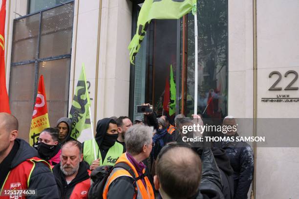 Demonstrators, including French General Confederation of Labour and Sud trade unionists, leave the Louis Vuitton store after they occupied the...