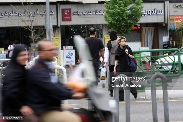 People walk on street as cameras are placed in public areas to detect women who violate the countryâs hijab law in Tehran, Iran on April 13, 2023.