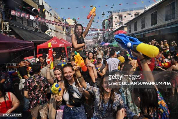 People take part in mass water fights during the first day of Songkran, or Thai New Year, on Khao San Road in Bangkok on April 13, 2023.