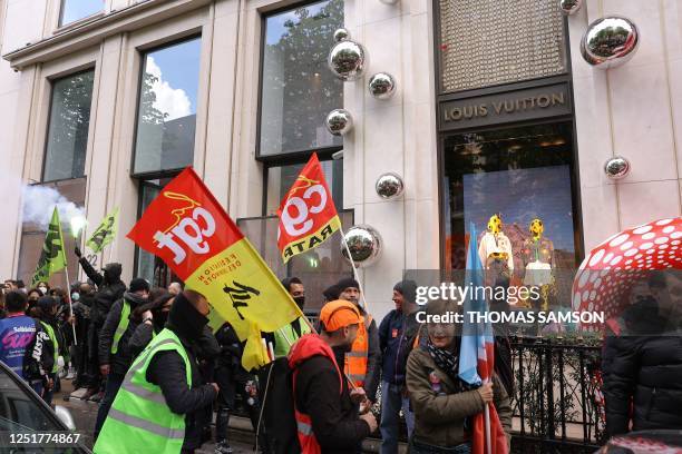 Demonstrators, including French General Confederation of Labour trade unionists, gather in front of the Louis Vuitton store and headquaters after...