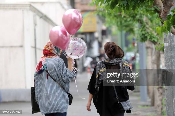 People walk on street as cameras are placed in public areas to detect women who violate the countryâs hijab law in Tehran, Iran on April 13, 2023.