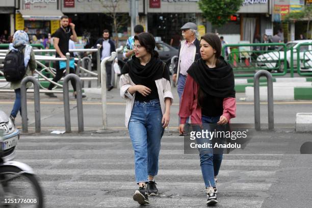 People walk on street as cameras are placed in public areas to detect women who violate the countryâs hijab law in Tehran, Iran on April 13, 2023.