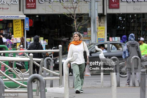 People walk on street as cameras are placed in public areas to detect women who violate the countryâs hijab law in Tehran, Iran on April 13, 2023.