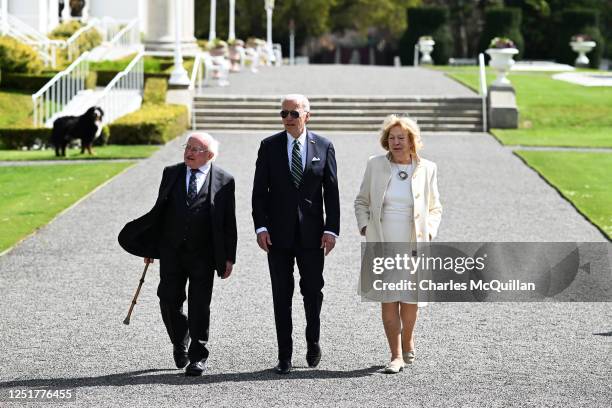 President Joe Biden walks Irish President Michael D Higgins and his wife Sabina Higgins in the grounds of the Irish President's official residence...