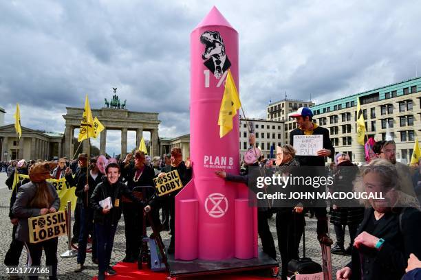 Climate activists of Extinction Rebellion wearing masks of company CEOs including Facebook's Mark Zuckerberg, Jeff Bezos, Richard Branson and Bill...