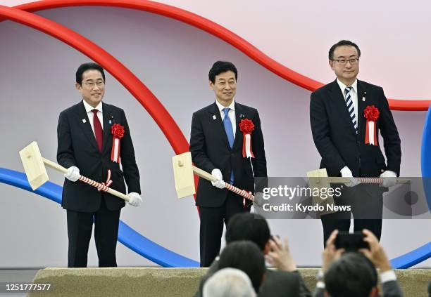 Japan's Prime Minister Fumio Kishida, Minister of Economy, Trade and Industry Yasutoshi Nishimura and Naoki Okada, minister for the 2025 World...