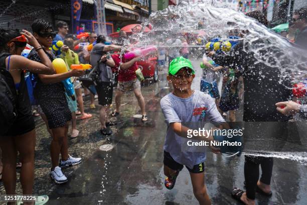 People take part in a water gun battle as part of the annual Songkran festival, also known as water festival, at the tourist spot of Khao San Road in...