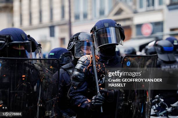 French CRS riot police officers walk during a demonstration on the 12th day of action after the government pushed a pensions reform through...