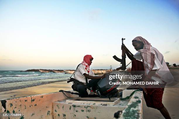 Photo taken on January 4, 2010 shows armed Somali pirates carrying out preparations to a skiff in Hobyo, northeastern Somalia, ahead of new attacks...