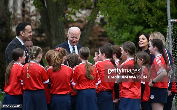 Ireland's Prime minister Leo Varadkar and US President Joe Biden speak with school-children as they put on a Gaelic sports demonstration in the field...