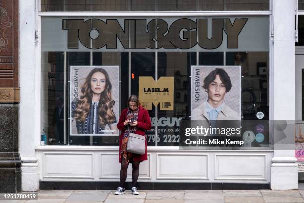 Woman outside the hairdresser Toni & Guy on 27th March 2023 in London, United Kingdom.