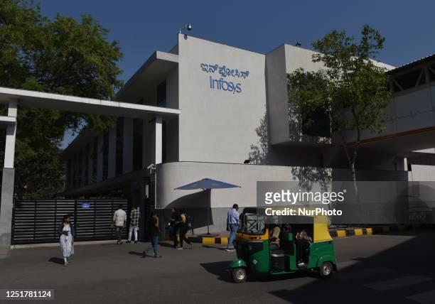 People walk past a gate of Infosys office in Bangalore, India, 13 April, 2023. Infosys, the second largest IT firm by sales, on Thursday reported a...