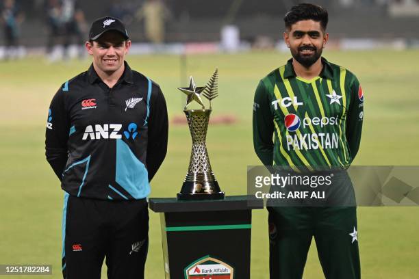 Pakistan's captain Babar Azam and his New Zealand's counterpart Tom Latham pose with the T20 series trophy at the Gaddafi Cricket Stadium in Lahore...
