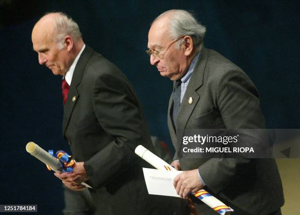 Polish journalist Ryszard Kapuscinski and Peruvian theologian Gustavo Gutierrez Merino walk back after being awarded the 2003 Communications and...