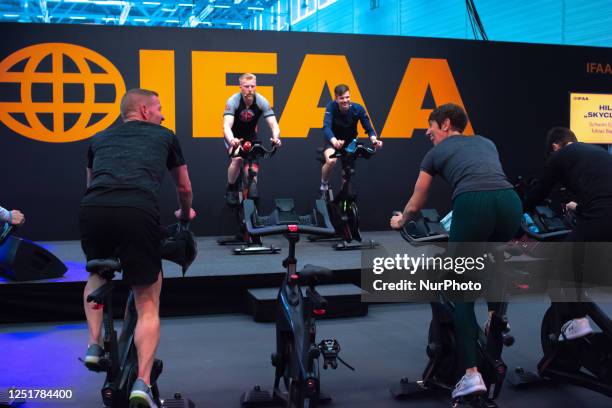 General view a group of bicycle training workout is seen during the FIBO 2023 opening on April 13, 2023 as FIBO is the leading trade show for fitness...