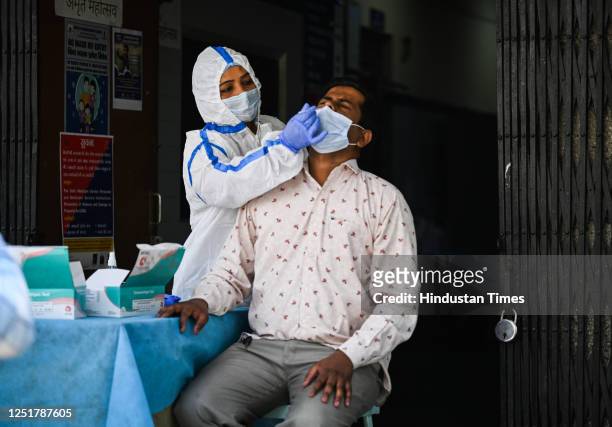 Health worker collects a swab sample for coronavirus testing at Delhi Government dispensary Daryaganj , on April 13, 2023 in New Delhi, India.