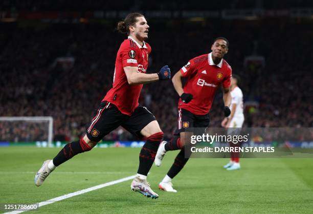 Manchester United's Austrian midfielder Marcel Sabitzer celebrates scoring the opening goal with Manchester United's French striker Anthony Martial...