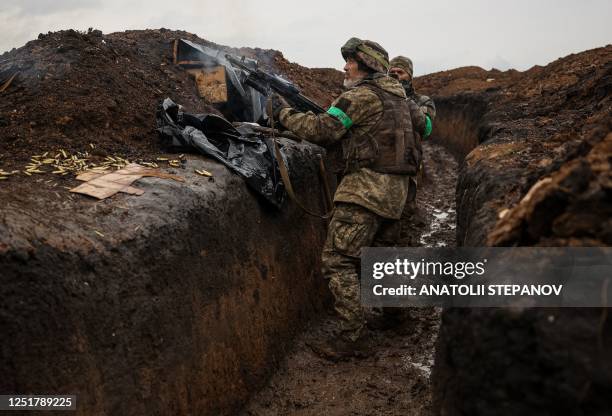 Ukrainian infantryman of the 57th Separate Motorized Infantry Brigade "Otaman Kost Khordienko" fires an AK 74 assault rifle with a grenade launcher...
