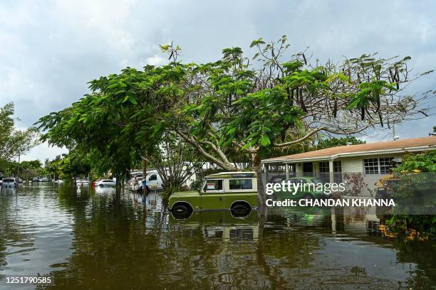 Vintage car is seen on the flooded street after heavy rain in Fort Lauderdale, Florida on April 13, 2023. - Torrential rain has drenched much of...