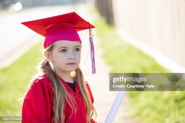 elementary age girl graduates kindergarten - portrait of a young girl with gappy teeth and blond hair stock pictures, royalty-free photos & images