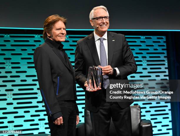 Anaheim, CA Singer-songwriter John Fogerty, left, accepts the Music for Life Award from Joe Lamond, president and CEO of the National Association of...