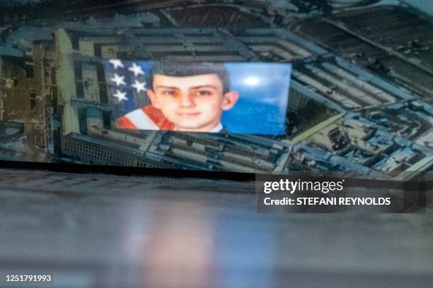 This photo illustration created on April 13 shows the suspect, national guardsman Jack Teixeira, reflected in an image of the Pentagon in Washington,...