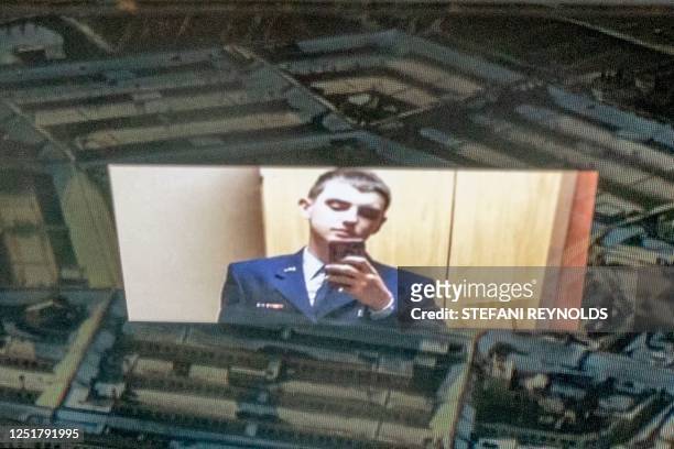 This photo illustration created on April 13 shows the suspect, national guardsman Jack Teixeira, reflected in an image of the Pentagon in Washington,...