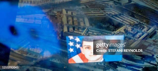 This photo illustration created on April 13 shows the Discord logo and the suspect, national guardsman Jack Teixeira, reflected in an image of the...