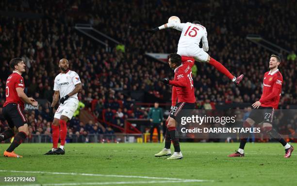 Sevilla's Moroccan forward Youssef En-Nesyri headers the ball to score a second goal, deflected in for an own goal off of Manchester United's English...